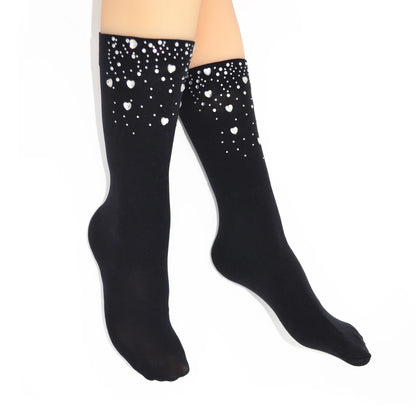 Black knee-high sock with crystal heart gems on a white background