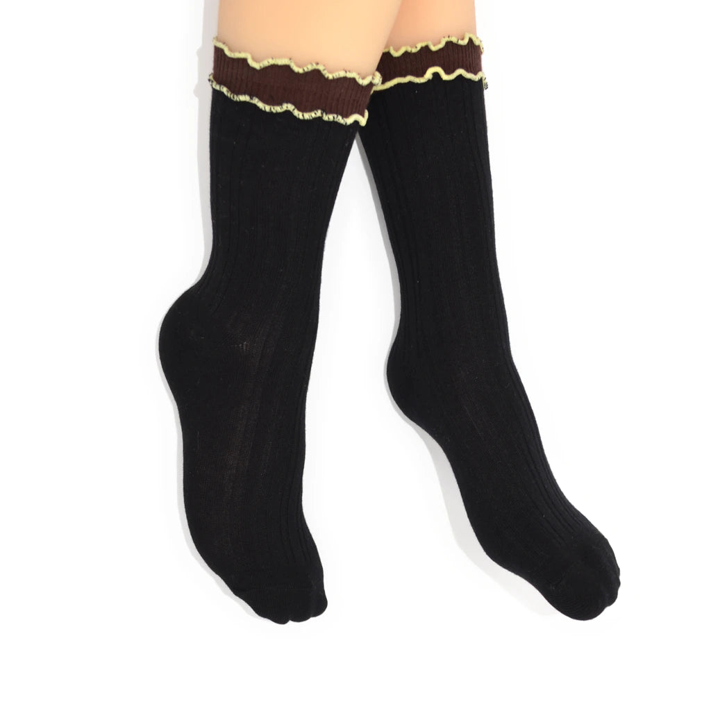 Black socks with brown trim and yellow edging trim on a white background