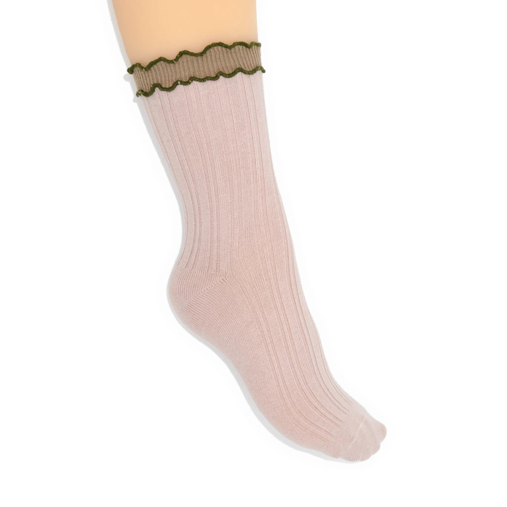 Beige sock with green ruffled top on a white background