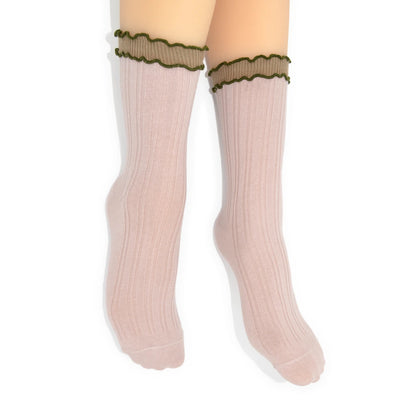 Pink crew socks with green lettuce trim on a white background