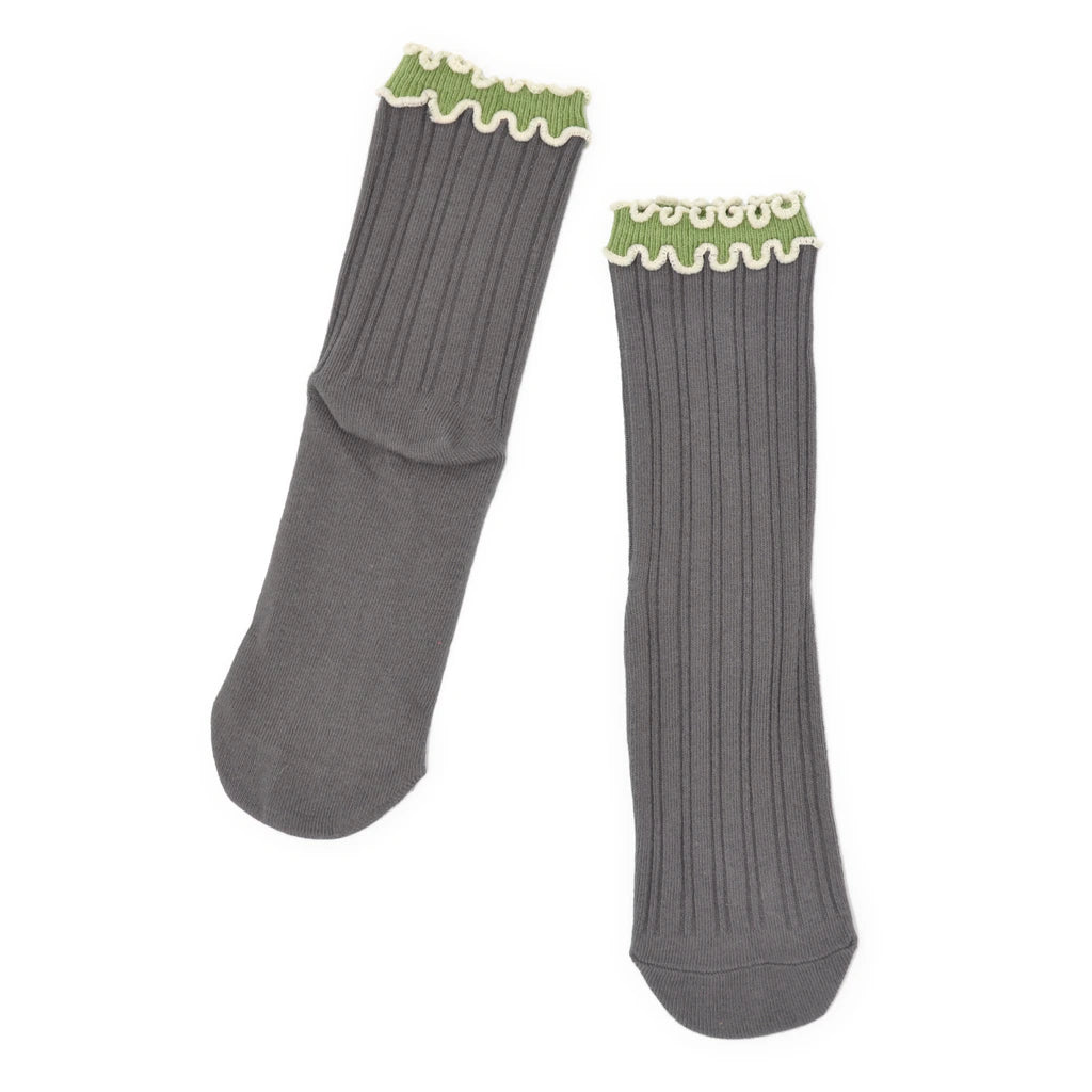 Pair of gray socks with green trim on a white background