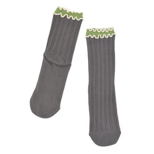 Pair of gray socks with green trim on a white background