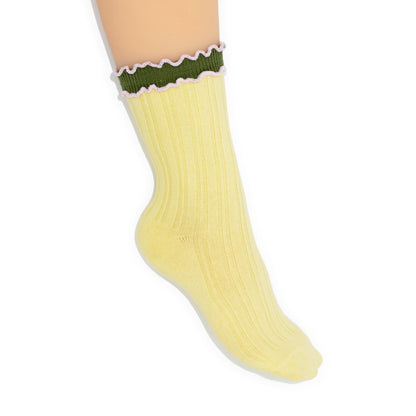 Yellow sock with green top on a white background