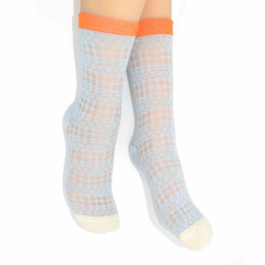 Legs modelling light blue socks with orange cuffs on a white background