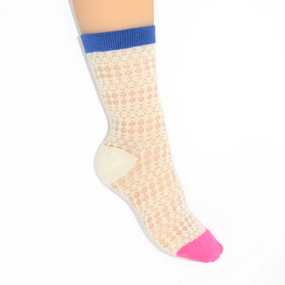 A leg modelling white socks with pink toes and cuffs on a white background