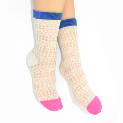 Legs modelling white socks with pink toes and cuffs on a white background