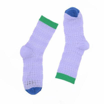Pair of light purple socks with green cuffs and blue toes on a white background