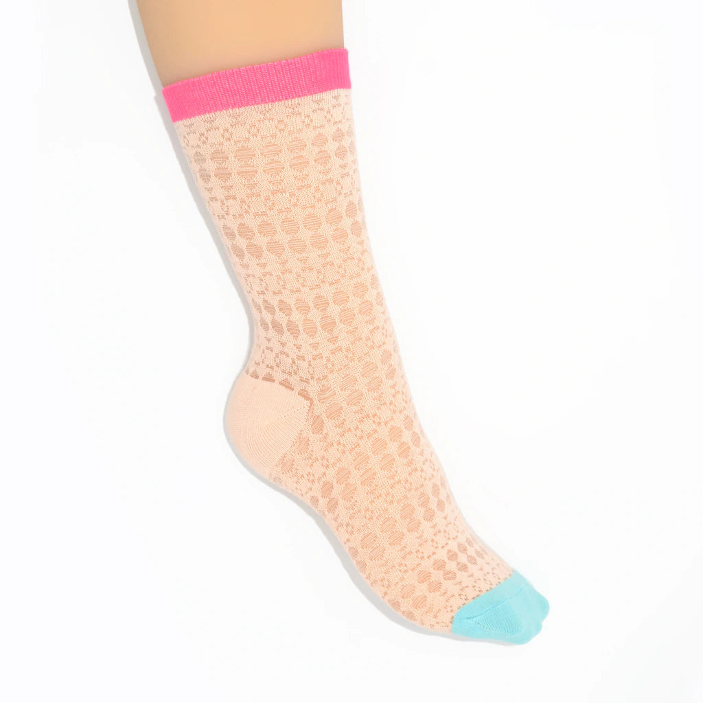 A leg modelling pink textured knit socks with pink and blue toes on a white background