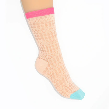 A leg modelling pink textured knit socks with pink and blue toes on a white background