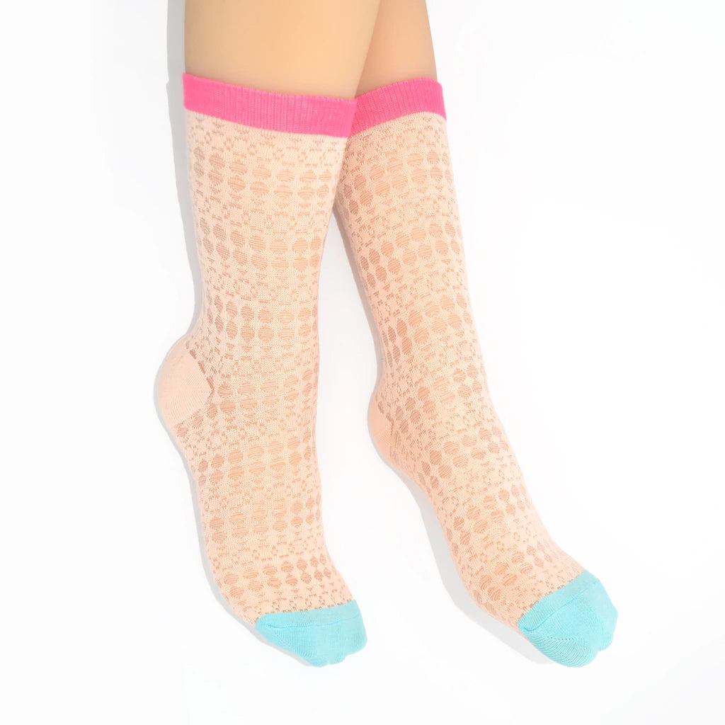Legs modelling pink textured knit socks with pink and blue toes on a white background