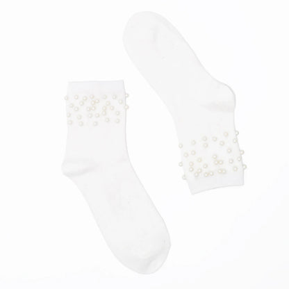 White ankle socks with pearl embellishments on a white background