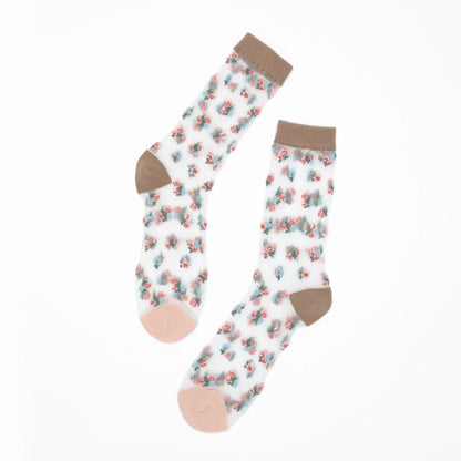 A pair of white crew socks with a small pink and blue floral pattern, featuring solid brown cuffs, heels, and toes, displayed on a clean white background.