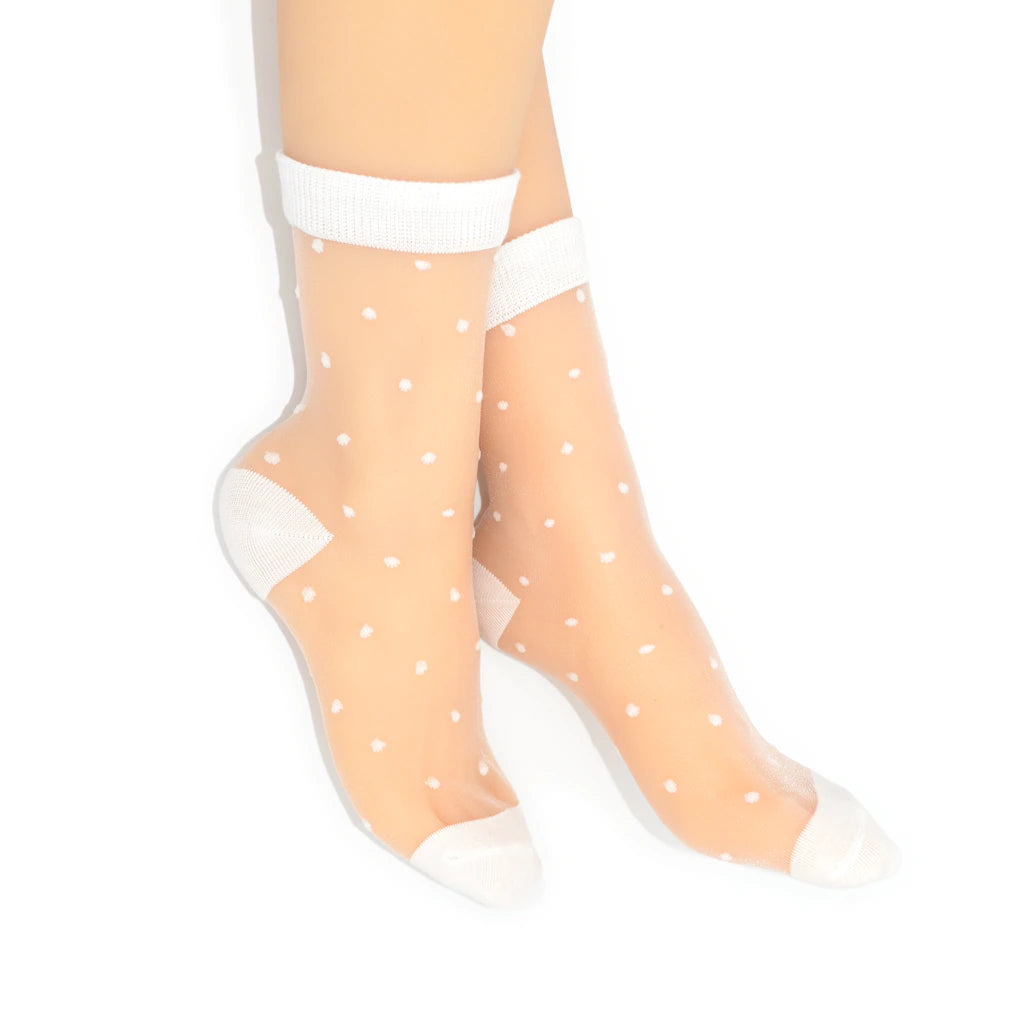 Sheer white socks with white polka dots and cuffs on a white background
